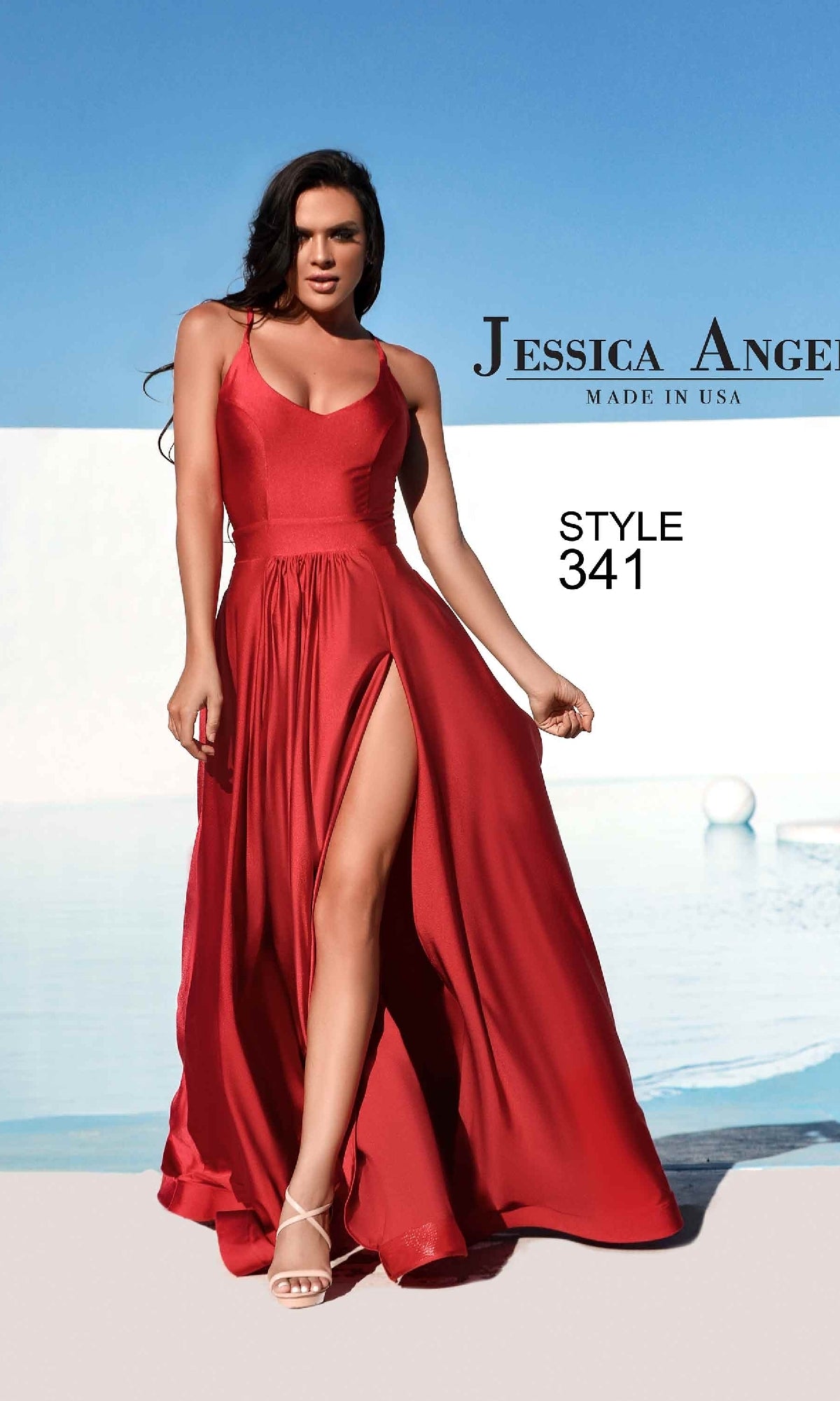 Woman in a sleeveless red strappy long A-line prom dress, Style 341 by Jessica Angel, standing outdoors by a pool.